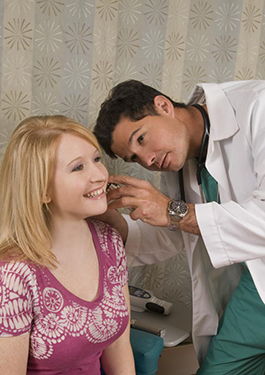 Dr. Cornish performing an ear examination.